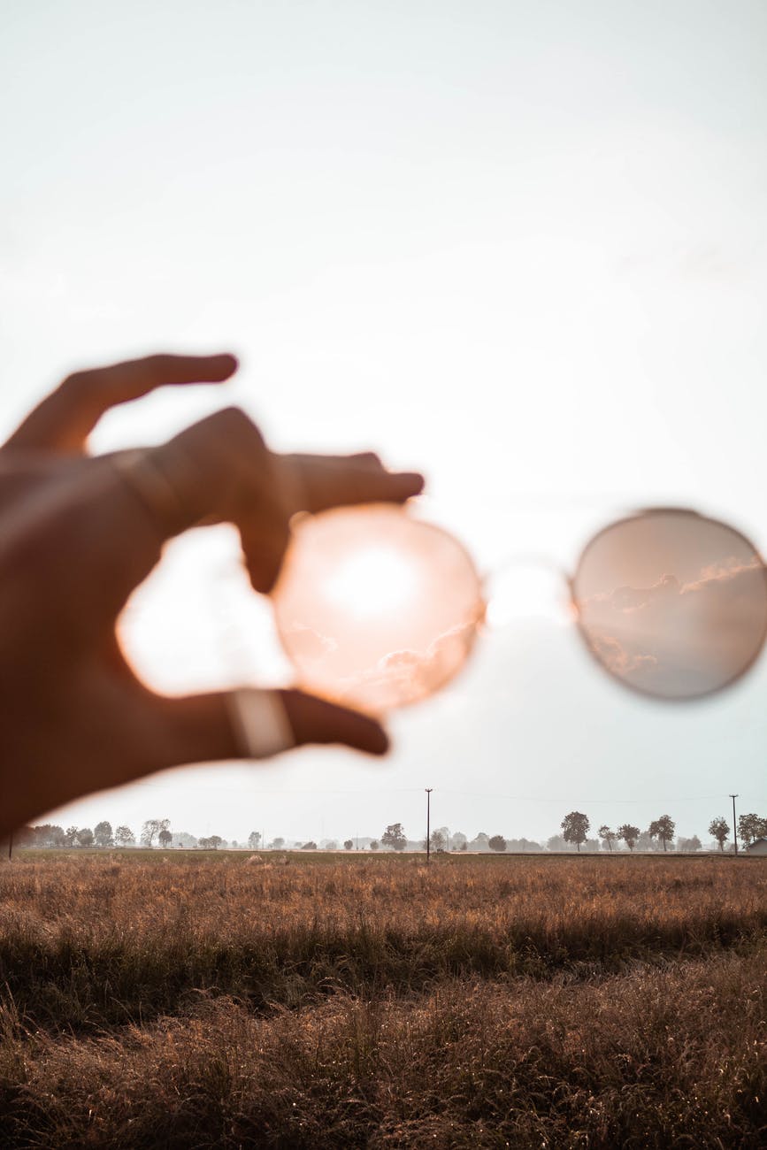 photo of person s hand holding a sunglasses