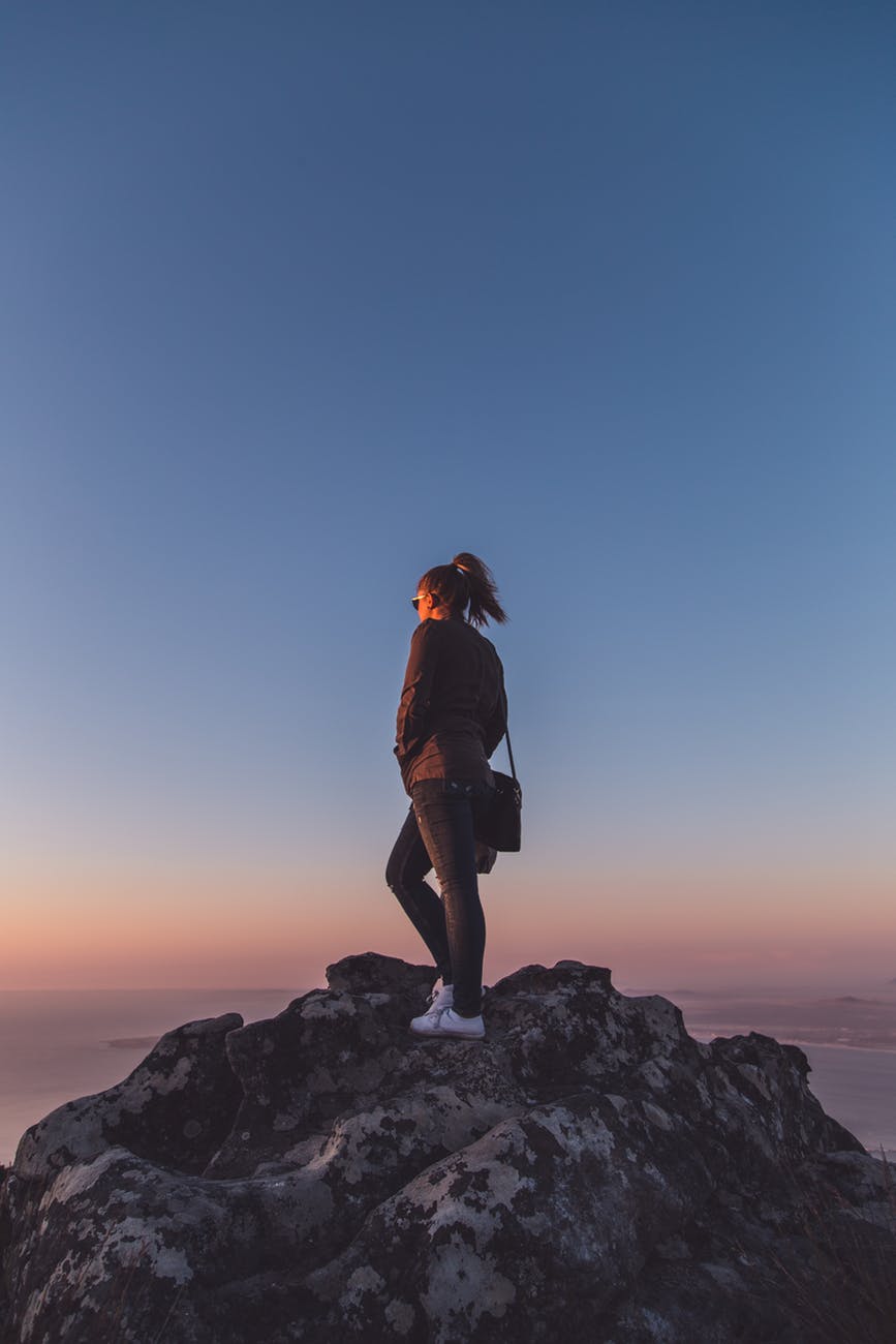 woman standing on rock